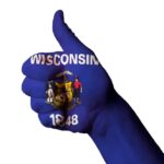 Thumb up hand sign painted to look like Wisconsin State flag